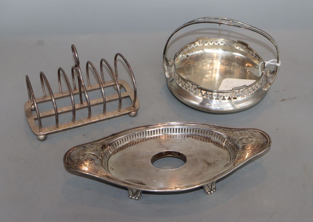 A silver basket, inkstand (no well) and a silver toastrack